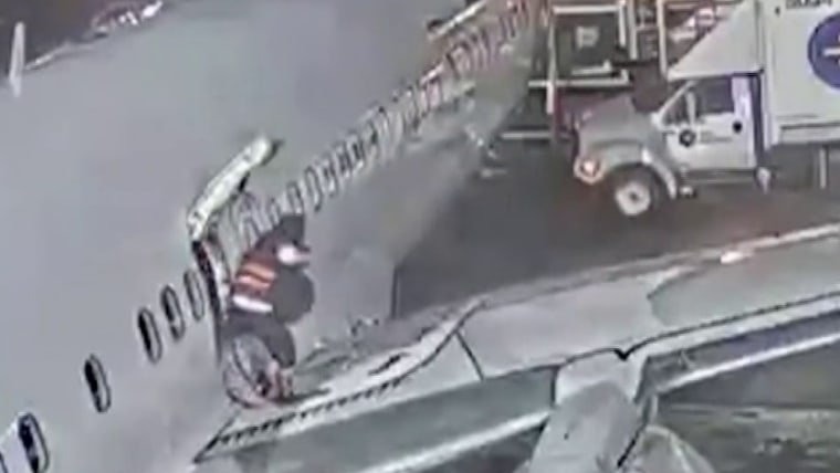 Video shows woman walking onto wing of Alaska Airlines plane