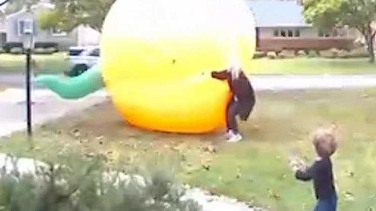 Mom scrambles to control giant inflatable pumpkin